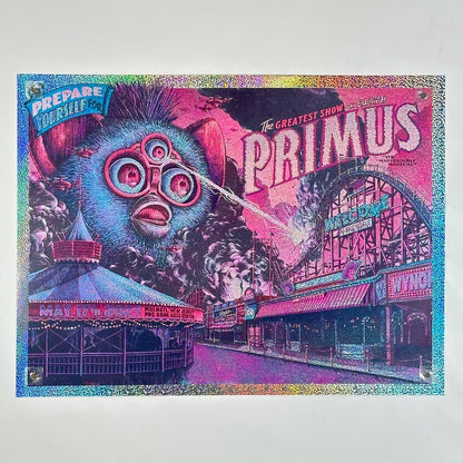 Glitter foil concert poster for Primus with a large blue Furby attacking amusement park, and vibrant text.