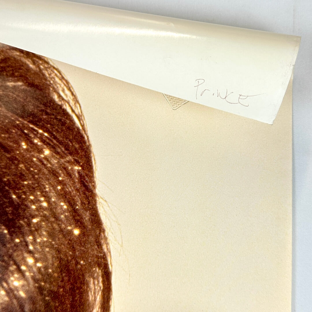 Top right corner rolled over to show artist name in pen on reverse side. 
