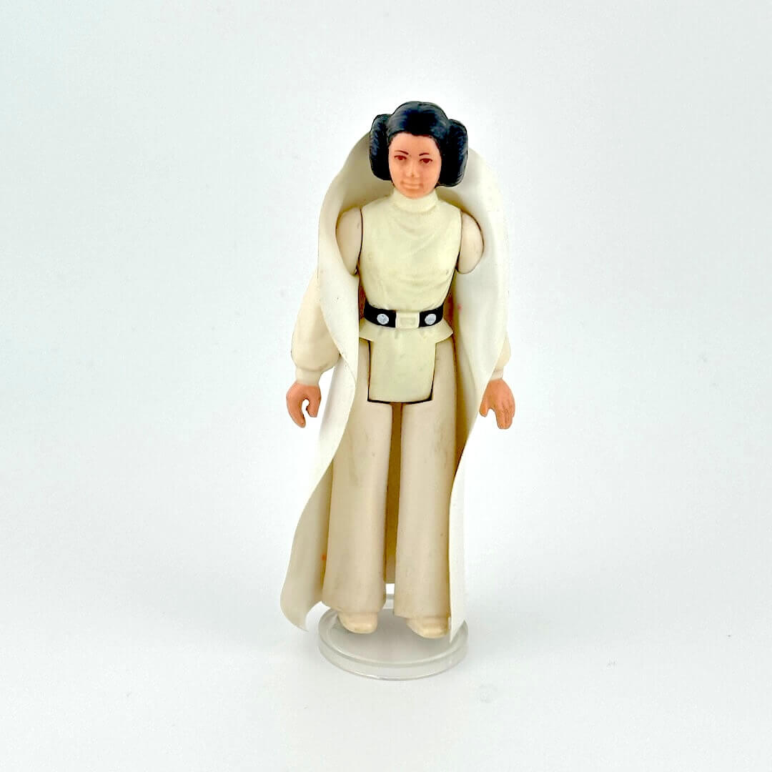 Princess Leia action figure in white outfit against white background.