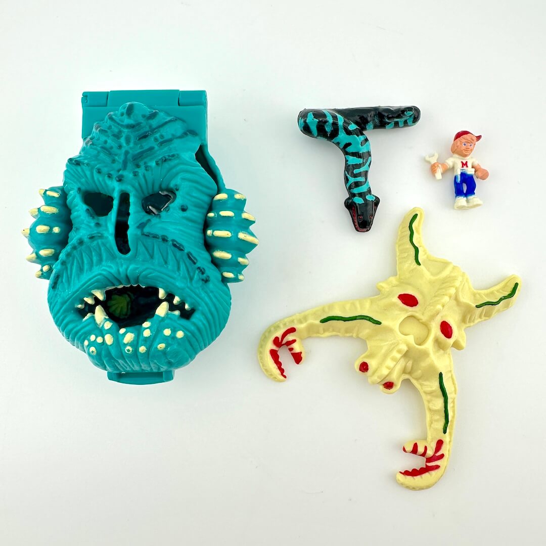 Toy playset with three smaller toys that fit inside against a white background. 
