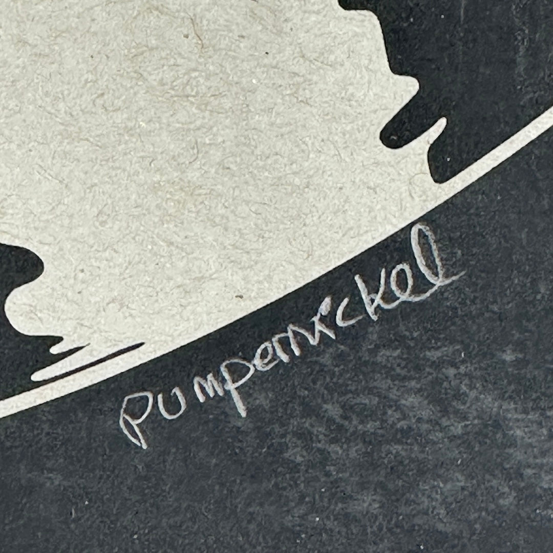 black poster with artist signature in pencil. 