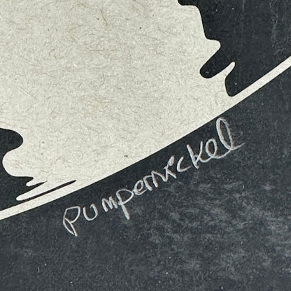 black poster with artist signature in pencil. 