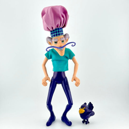 Toy figure of a character with a purple hat and blue outfit, standing next to a small bird-like creature on a white background.