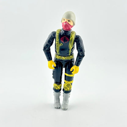 A toy action figure of a character wearing a gray beanie, pink face mask, black and yellow suit, and gray boots.