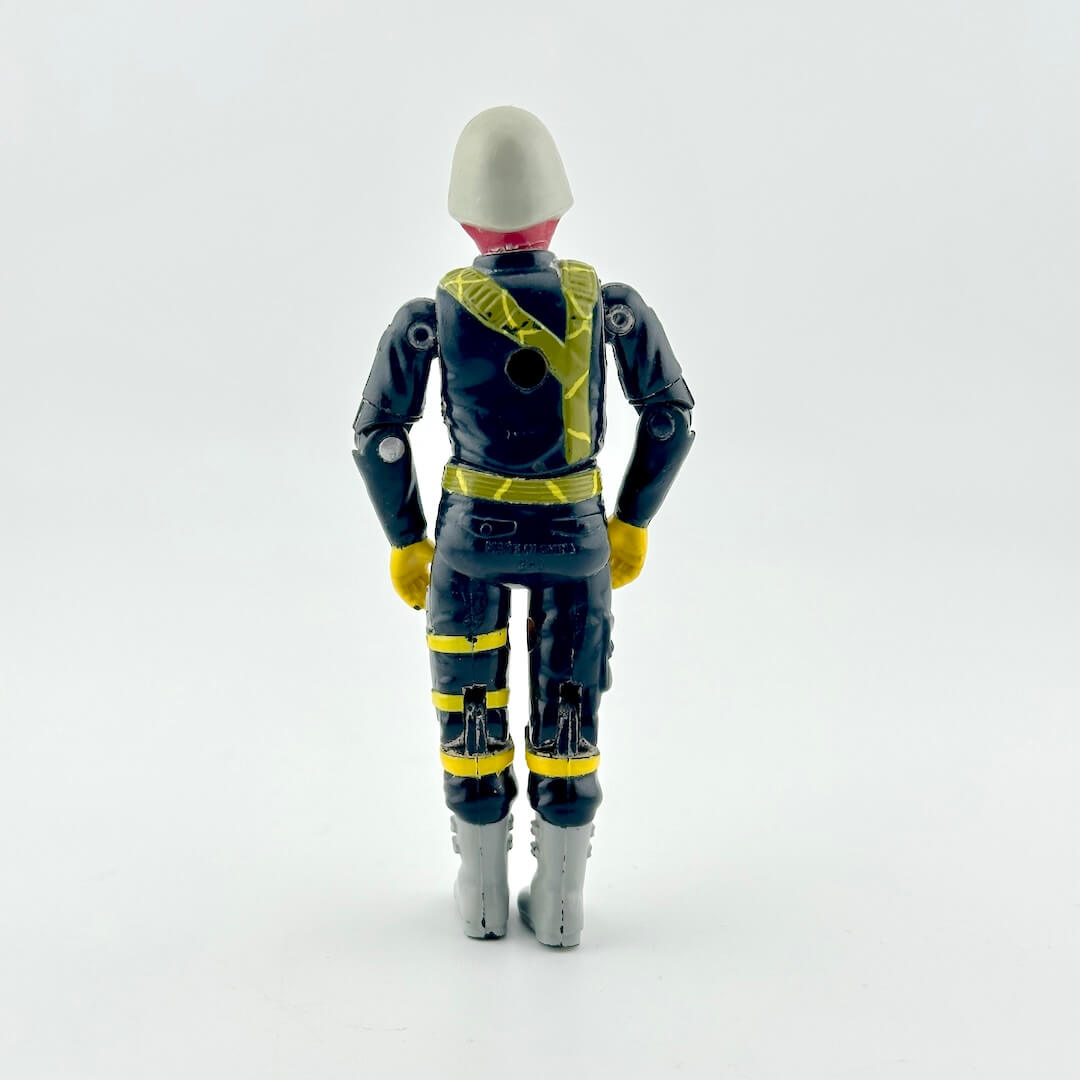 A toy action figure shown from the back, wearing a black and yellow futuristic suit with a gray helmet and gray boots.