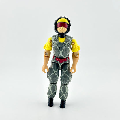 Action figure wearing a gray and green camouflage patterned suit with yellow sleeves, a red visor, and a yellow helmet.
