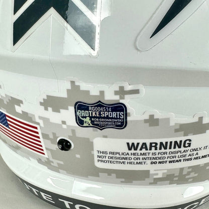 Close-up of a helmet with digital camouflage pattern, American flag, and Radtke Sports branding.