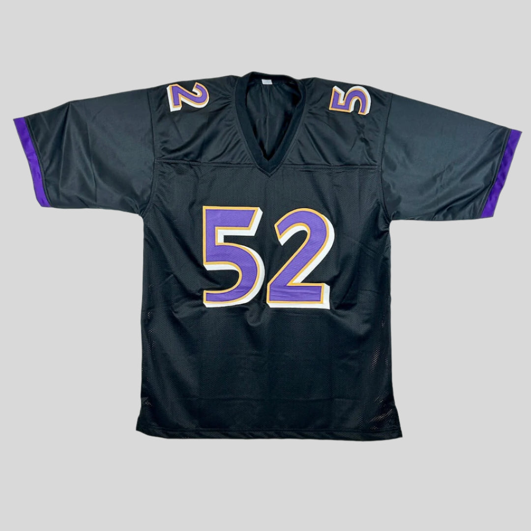 Black sports jersey with numbers 52 in purple with yellow and white outlining on a gray background
