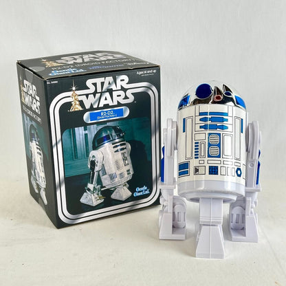 Star Wars R2-D2 action figure shown next to its original box on a light neutral background.
