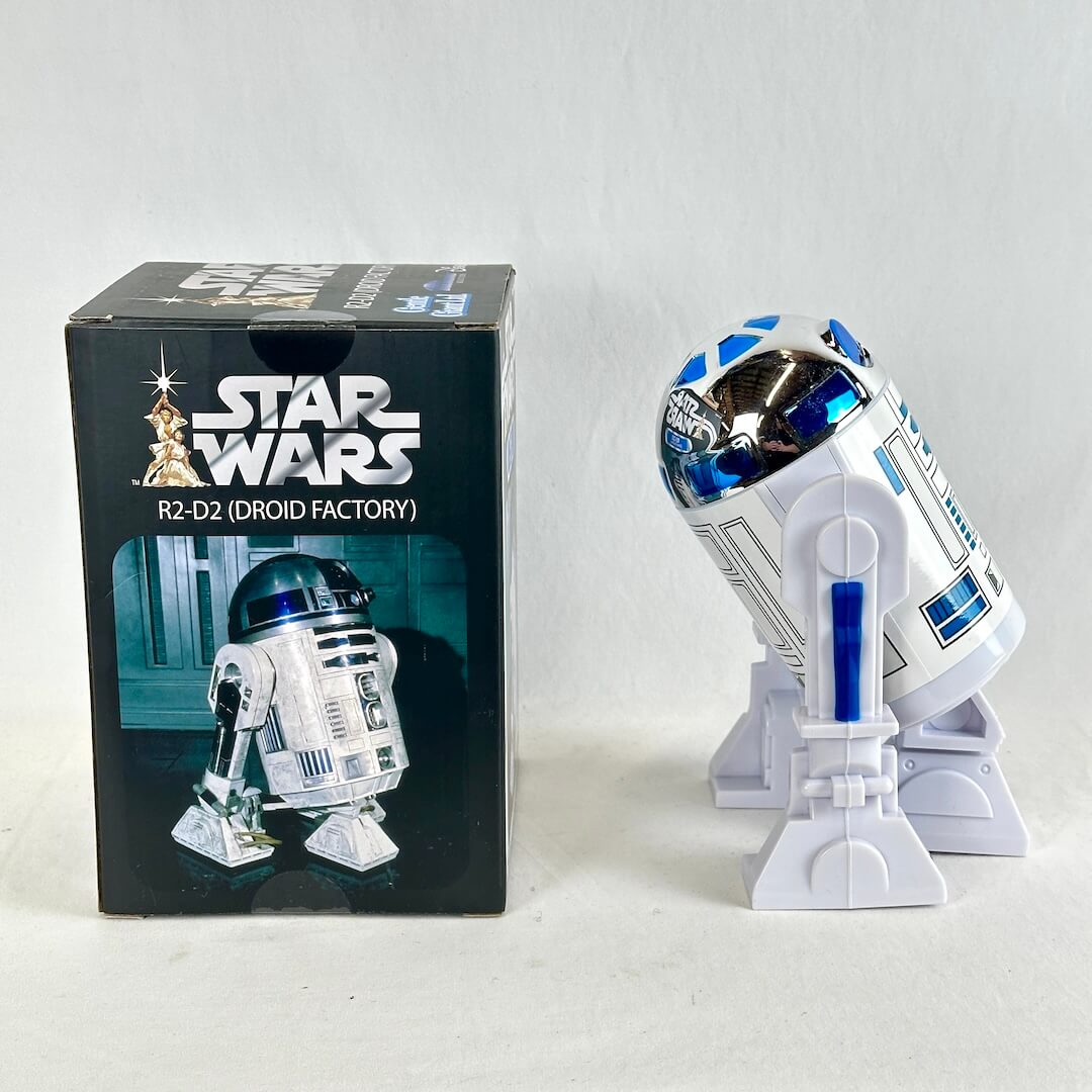 Star Wars R2-D2 'Droid Factory' collectible figure shown next to its original black packaging box.