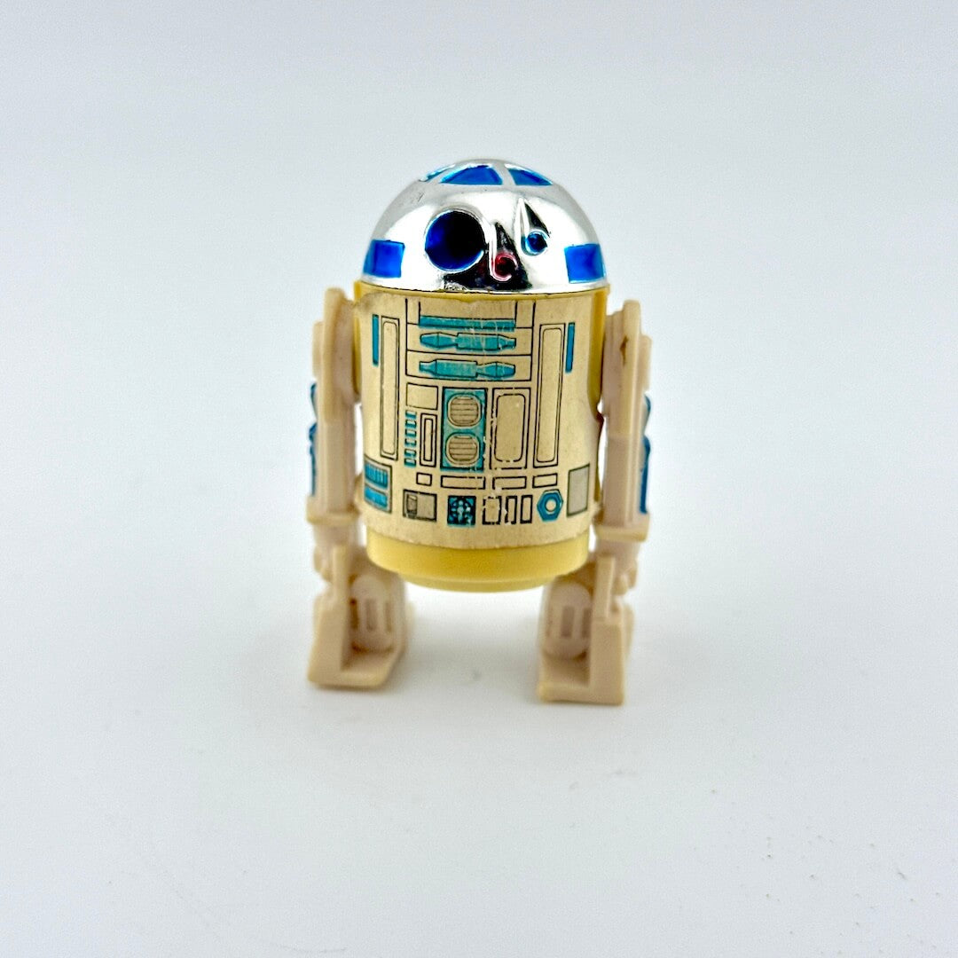 Toy robot resembling R2-D2 from Star Wars on a white background