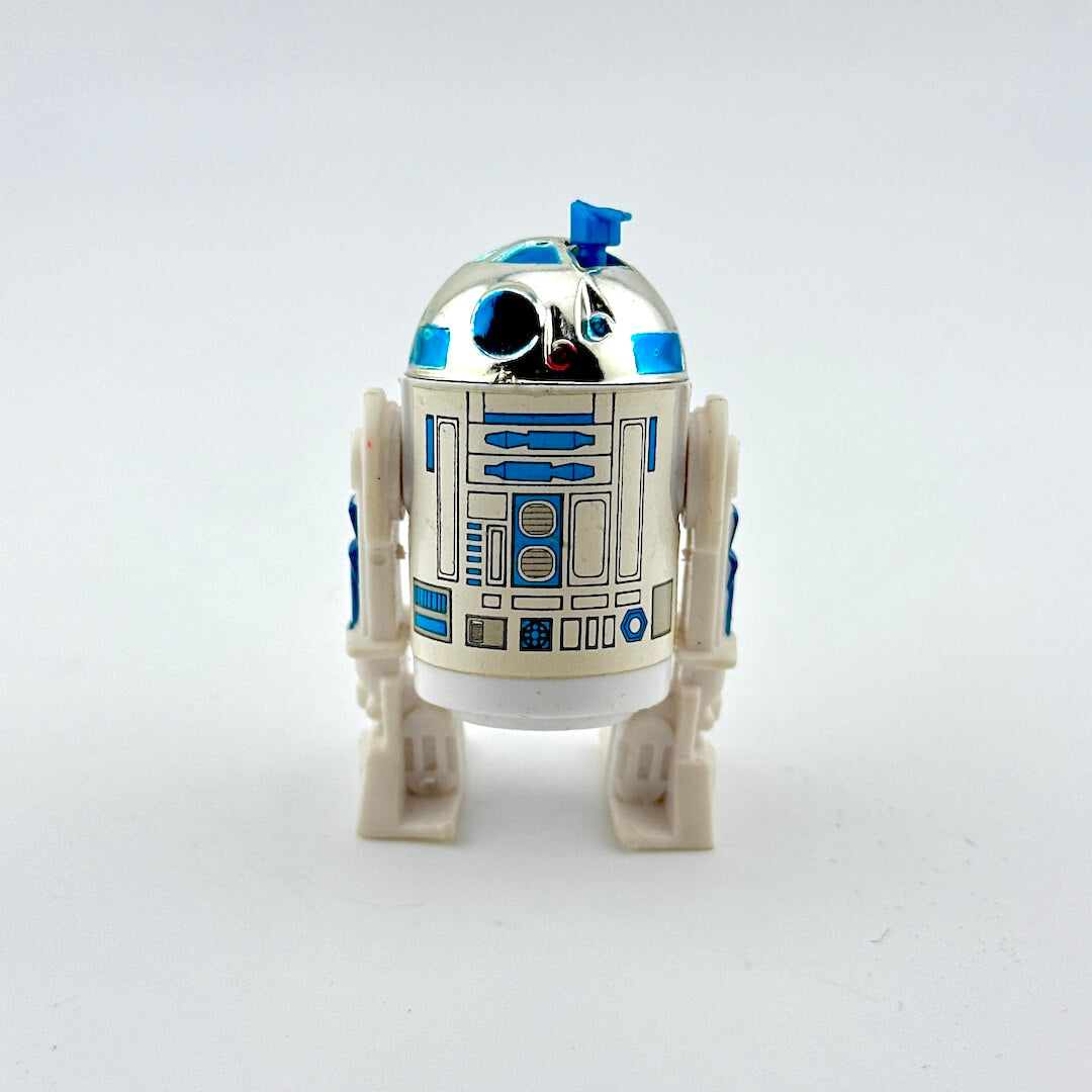 Toy robot resembling R2-D2 from Star Wars on a white background