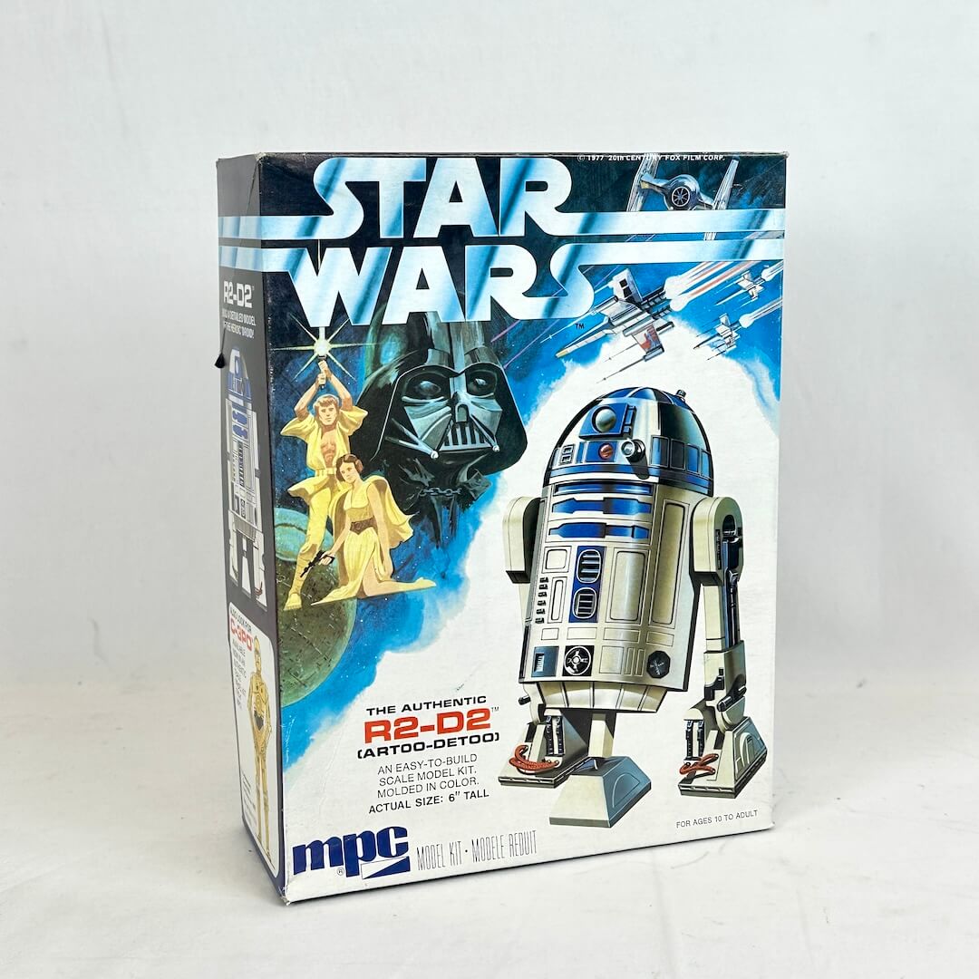 Box of Star Wars R2-D2 model kit with Darth Vader and Luke Skywalker on a blue background