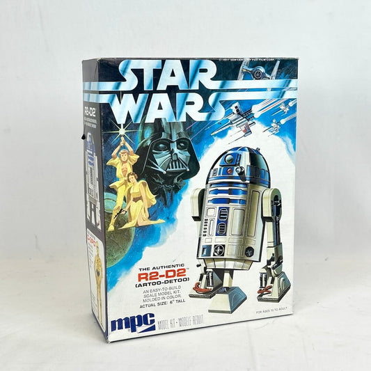 Box of Star Wars R2-D2 model kit with Darth Vader and Luke Skywalker on a blue background