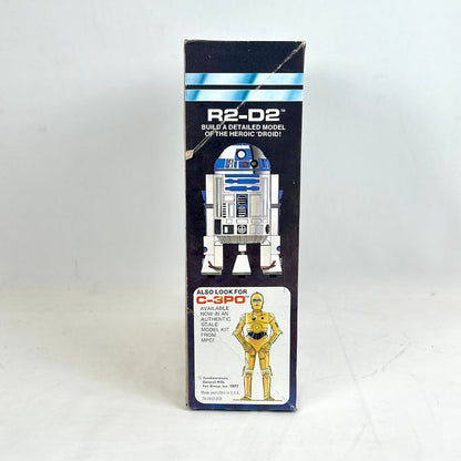 Vintage R2-D2 toy packaging from Star Wars on a white background