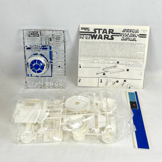 Star Wars R2-D2 model kit with assembly manual and parts on a white background