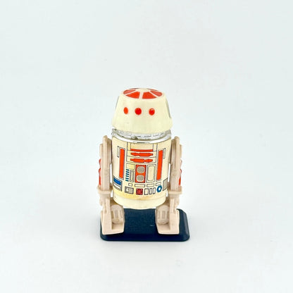 Small robot action figure, R5-D4, on a white background