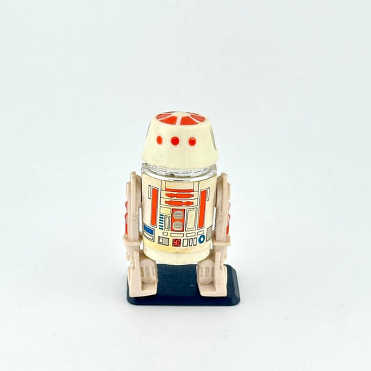 Small robot action figure, R5-D4, on a white background