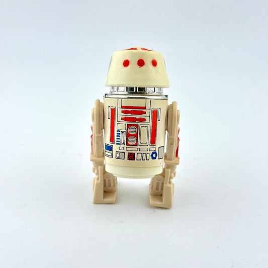 Toy figure of a robot with a white and beige color scheme on a light gray background