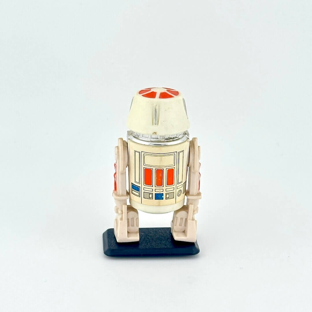 Small robot action figure, R5-D4, on a white background