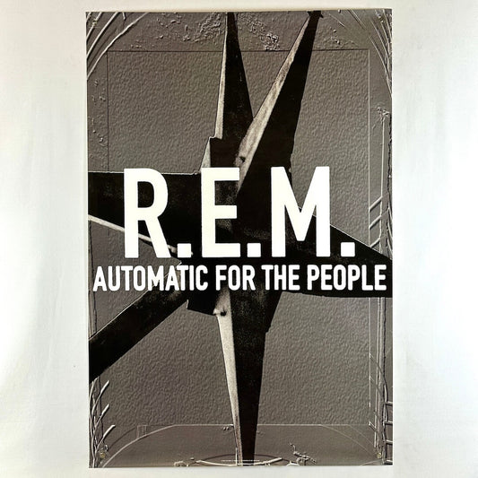 Poster for REM album "Automatic for the People" with gray background and gray spiked thing as center graphic behind text