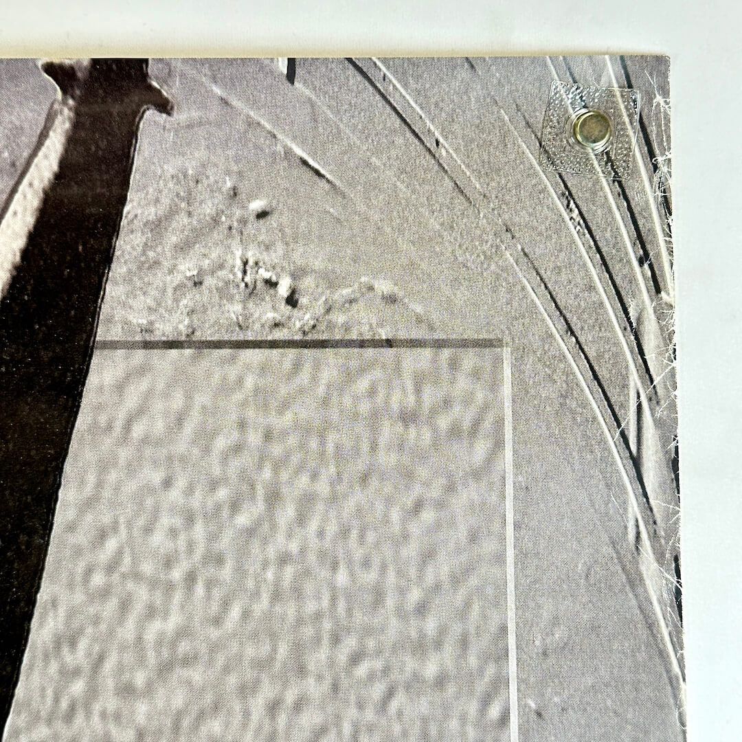 Top right corner with wear along right edge. 
