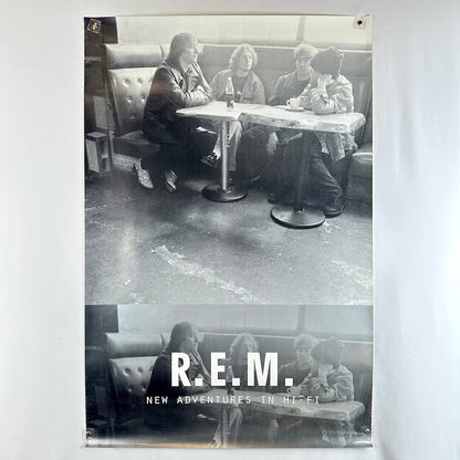 Black and white poster of R.E.M. sitting in a diner with album title 'New Adventures in Hi-Fi'.