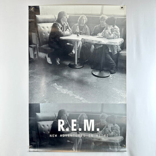 Black and white poster of R.E.M. sitting in a diner with album title 'New Adventures in Hi-Fi'.