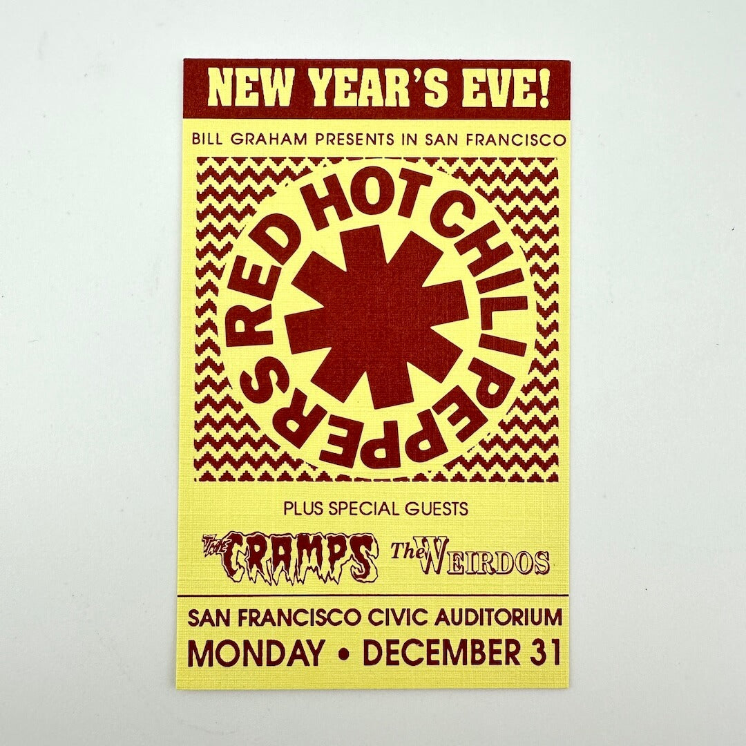 Red text on yellow background event ticket for Red Hot Chili Peppers, their logo in center. 