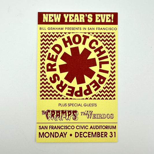 Red text on yellow background event ticket for Red Hot Chili Peppers, their logo in center. 