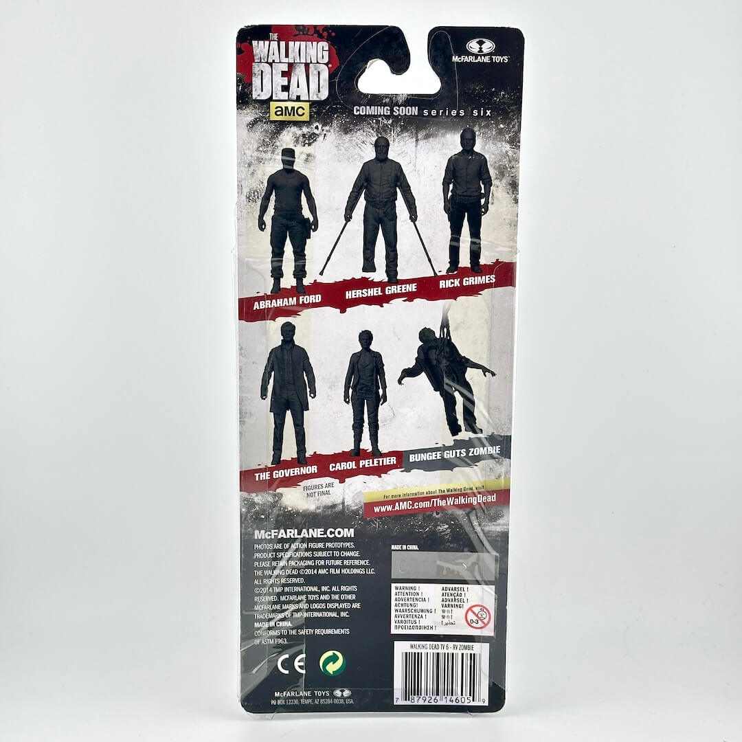 Back of a McFarlane Toys Walking Dead action figure blister card package, showing characters and product information.