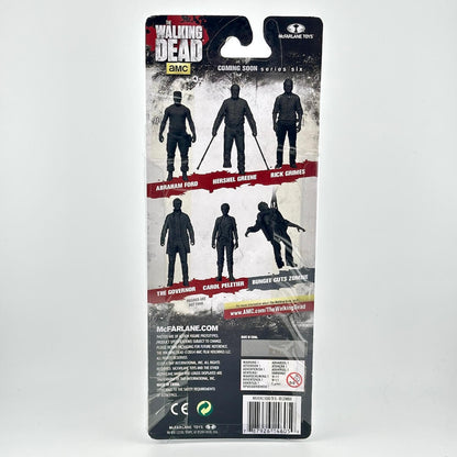 Back of a McFarlane Toys Walking Dead action figure blister card package, showing characters and product information.