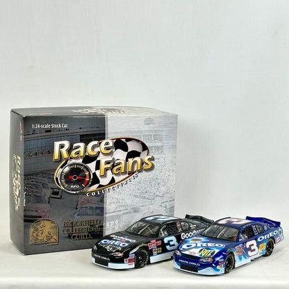 Two model race cars in front of their packaging with 'Race Fans' branding.