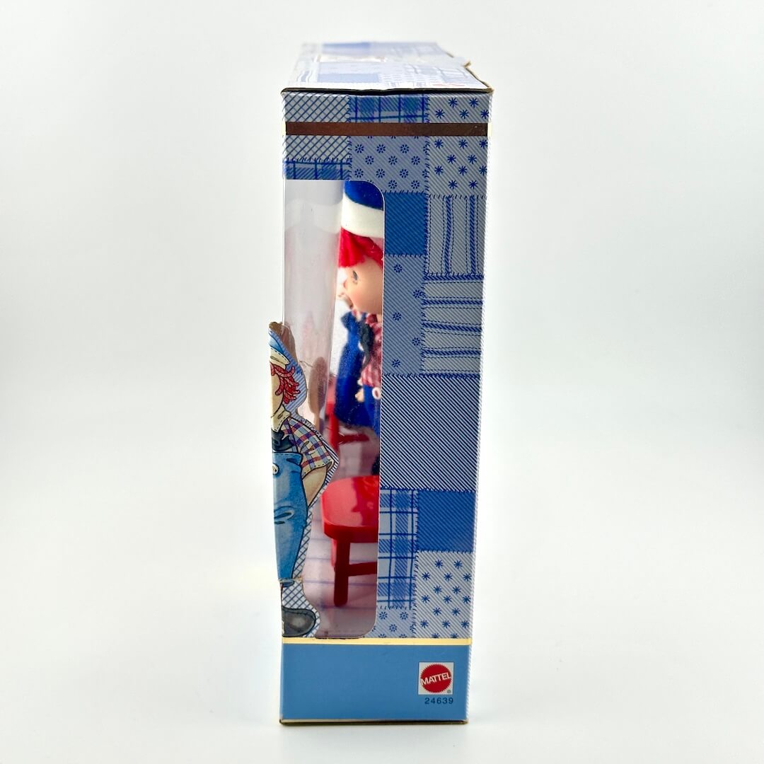 Toy figure in a blue box with a visible brand logo on a white background