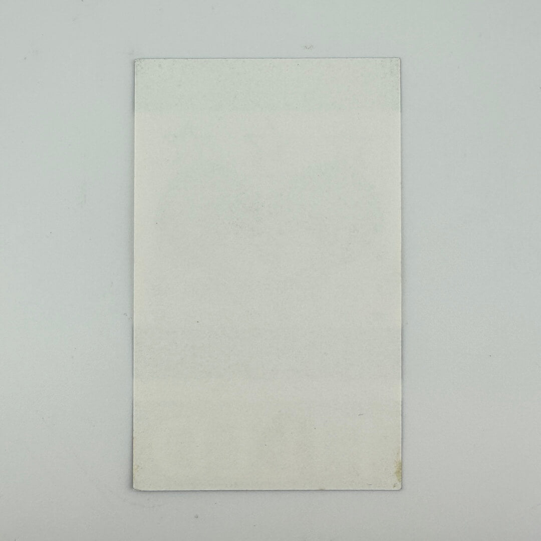 Reverse side of ticket showing perfect condition against white background. 
