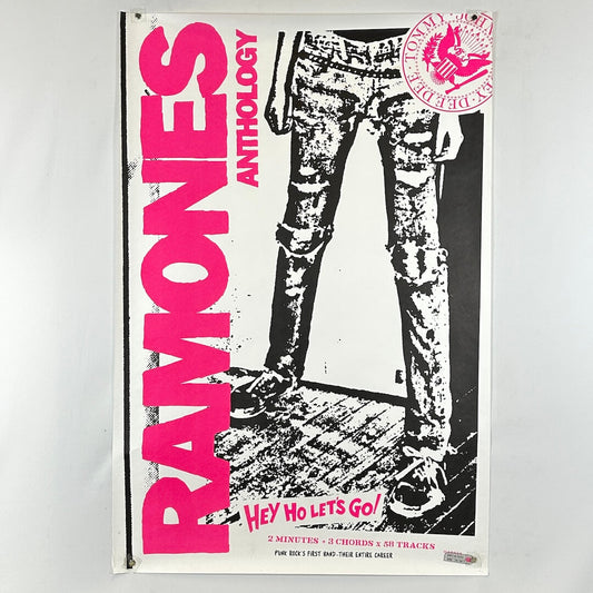 Poster of Ramones Anthology with pink text and black and white graphic of legs wearing jeans.