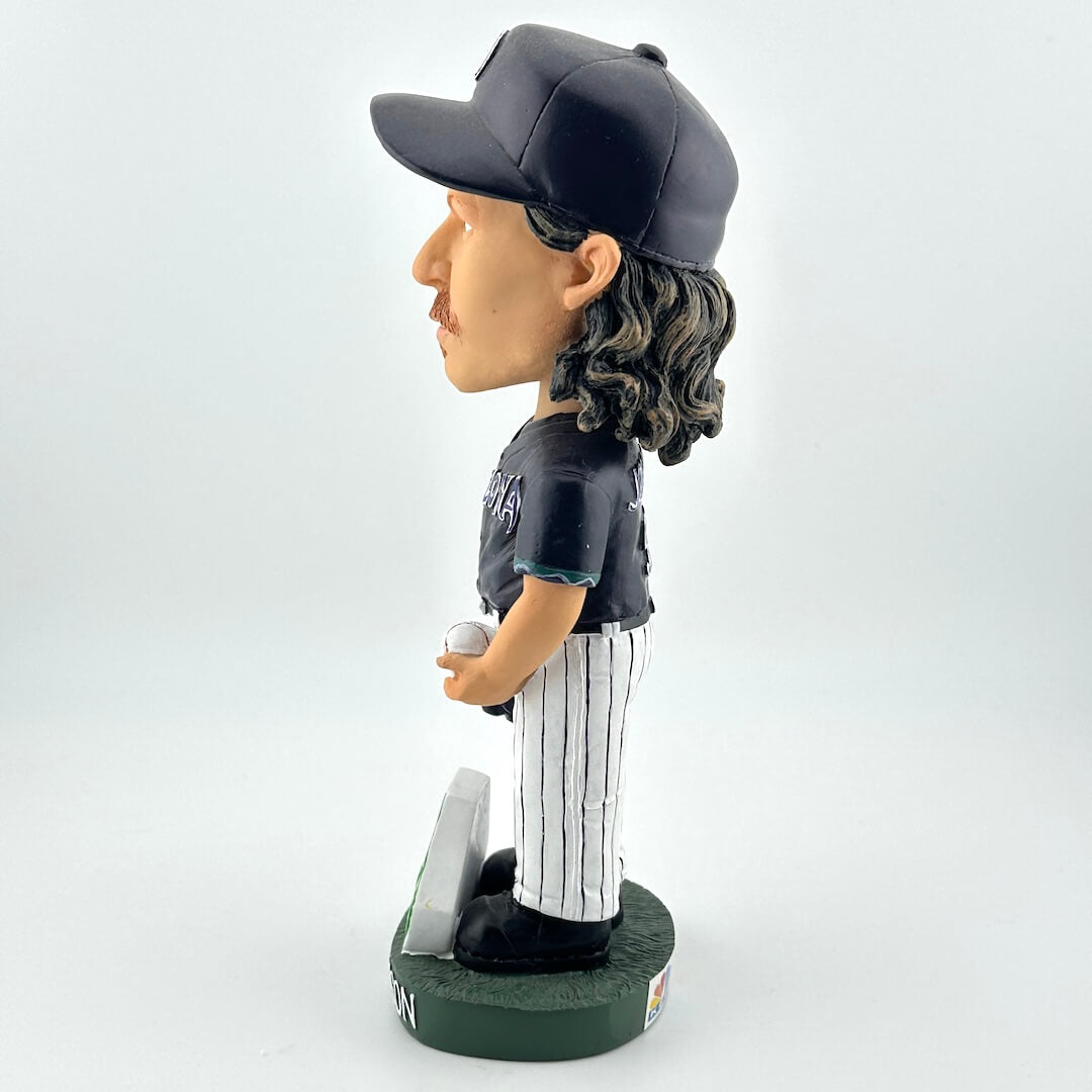Bobblehead figure of a baseball player wearing a cap and uniform on a white background