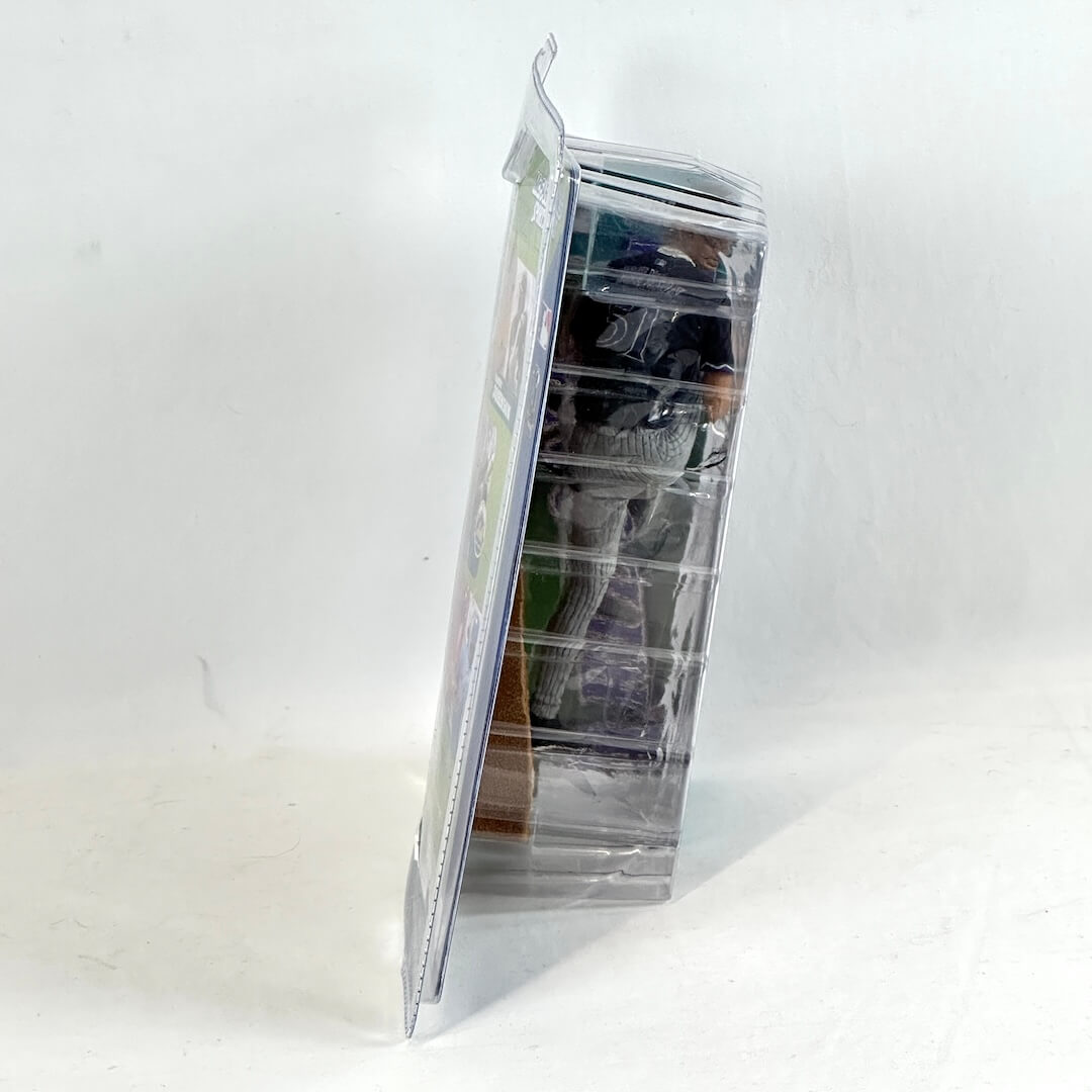 Clear plastic packaging with a stack of books inside on a white background
