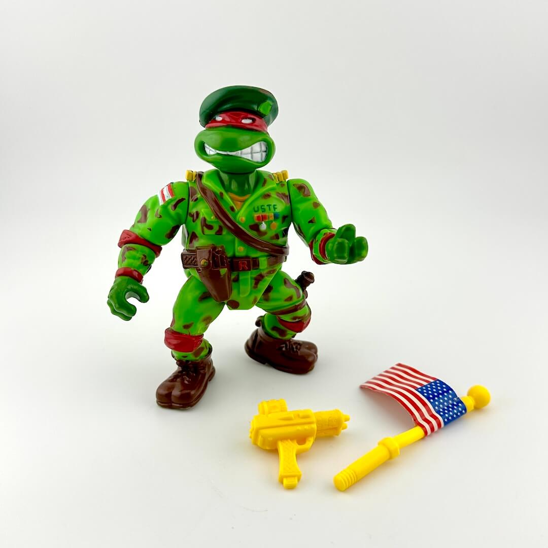 Toy figure in green camouflage with accessories on a white background