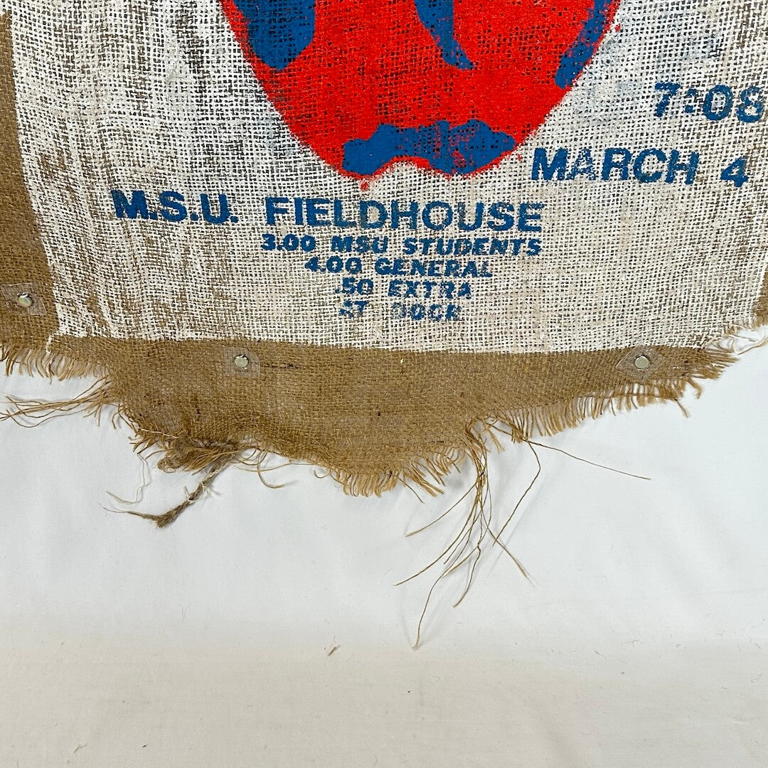 Burlap fabric with printed text and a red and blue design on a white background