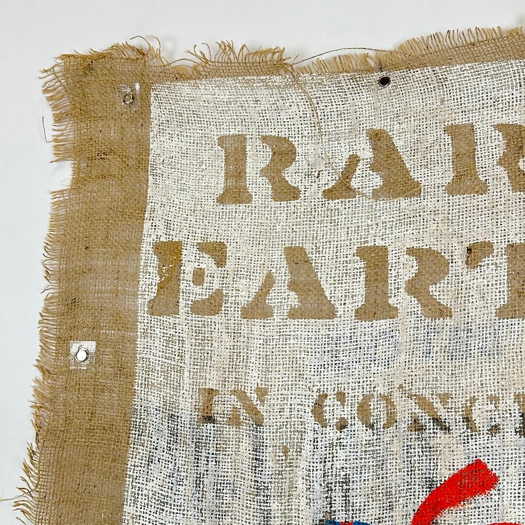 Textured fabric with 'RARE EARTH' printed on it, corner view.