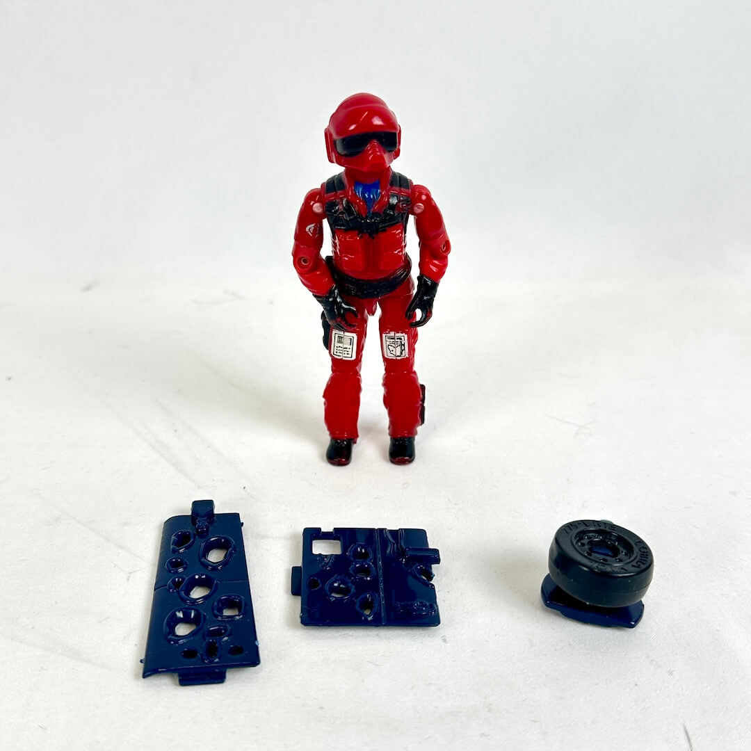 Red action figure with helmet and black parts on a white background