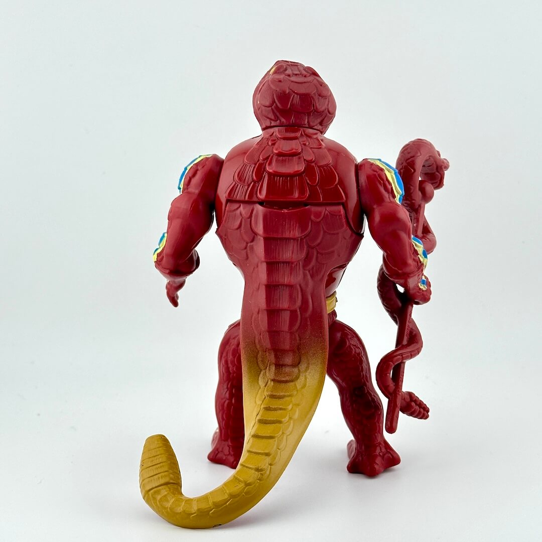 Snake-man action figure with staff against white background.