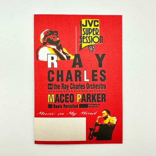 Red fabric backstage pass for Ray Charles with yellow and black print and two images of artists. 