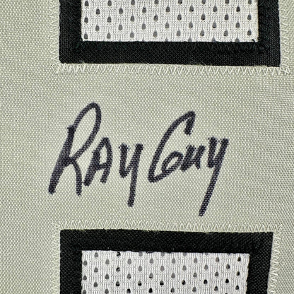 Signature of 'Ray Guy' on a textured number patch on jersey background