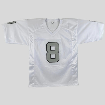 White sports jersey with silver number 8 with black outline on a gray background
