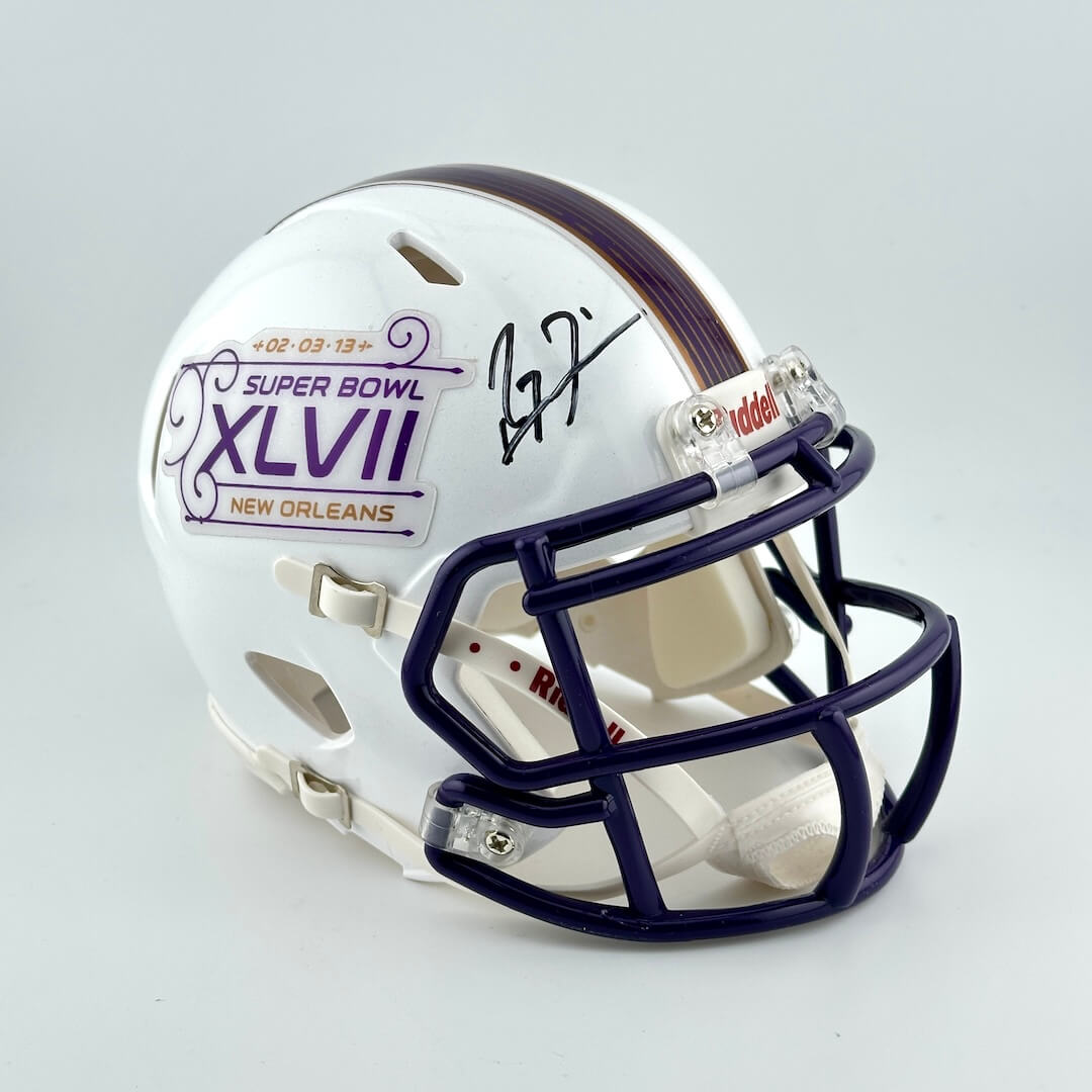 Miniature football helmet with Super Bowl XLVII branding on a gray background