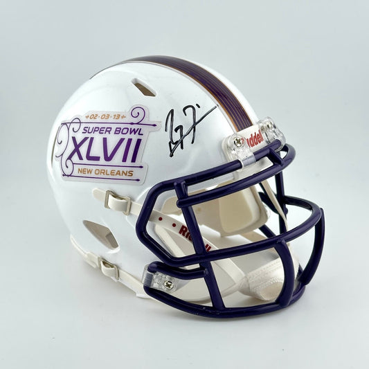 Miniature football helmet with Super Bowl XLVII branding on a gray background