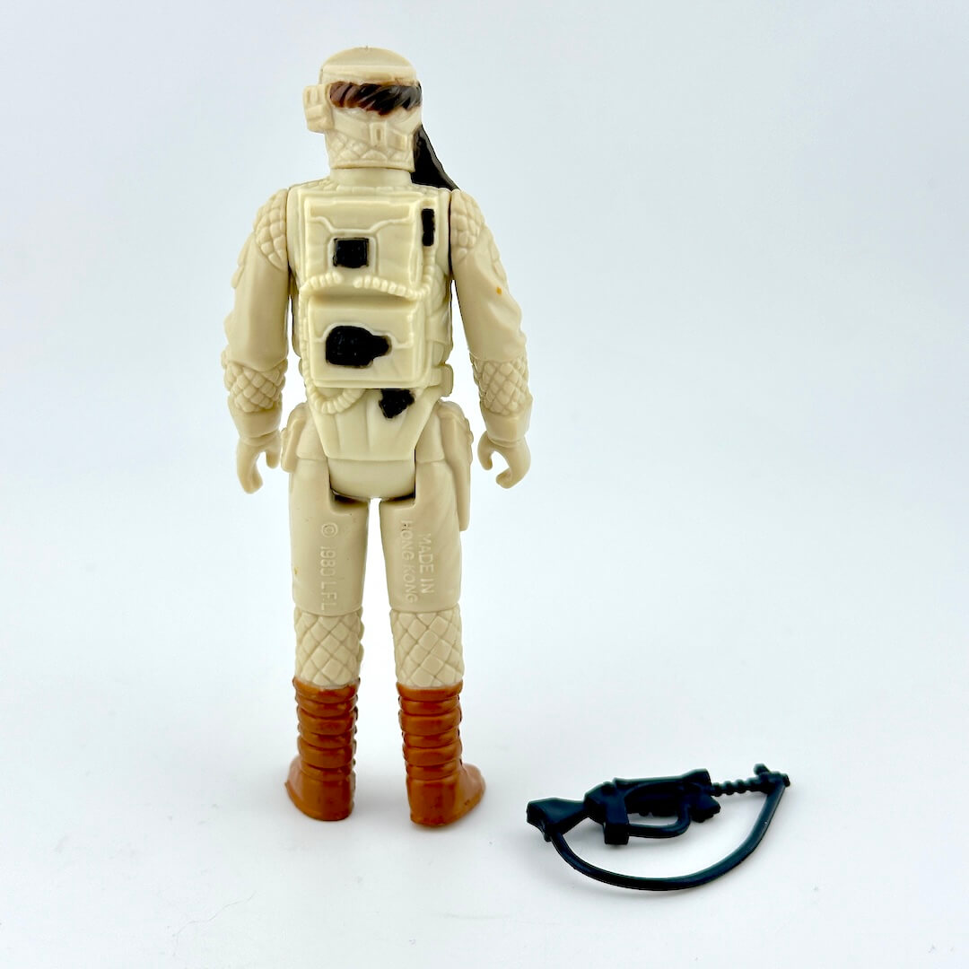 Vintage action figure in beige space suit with brown boots on a white background