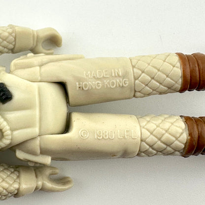Close-up of a toy figure with 'Made in Hong Kong' and copyright text on a white background
